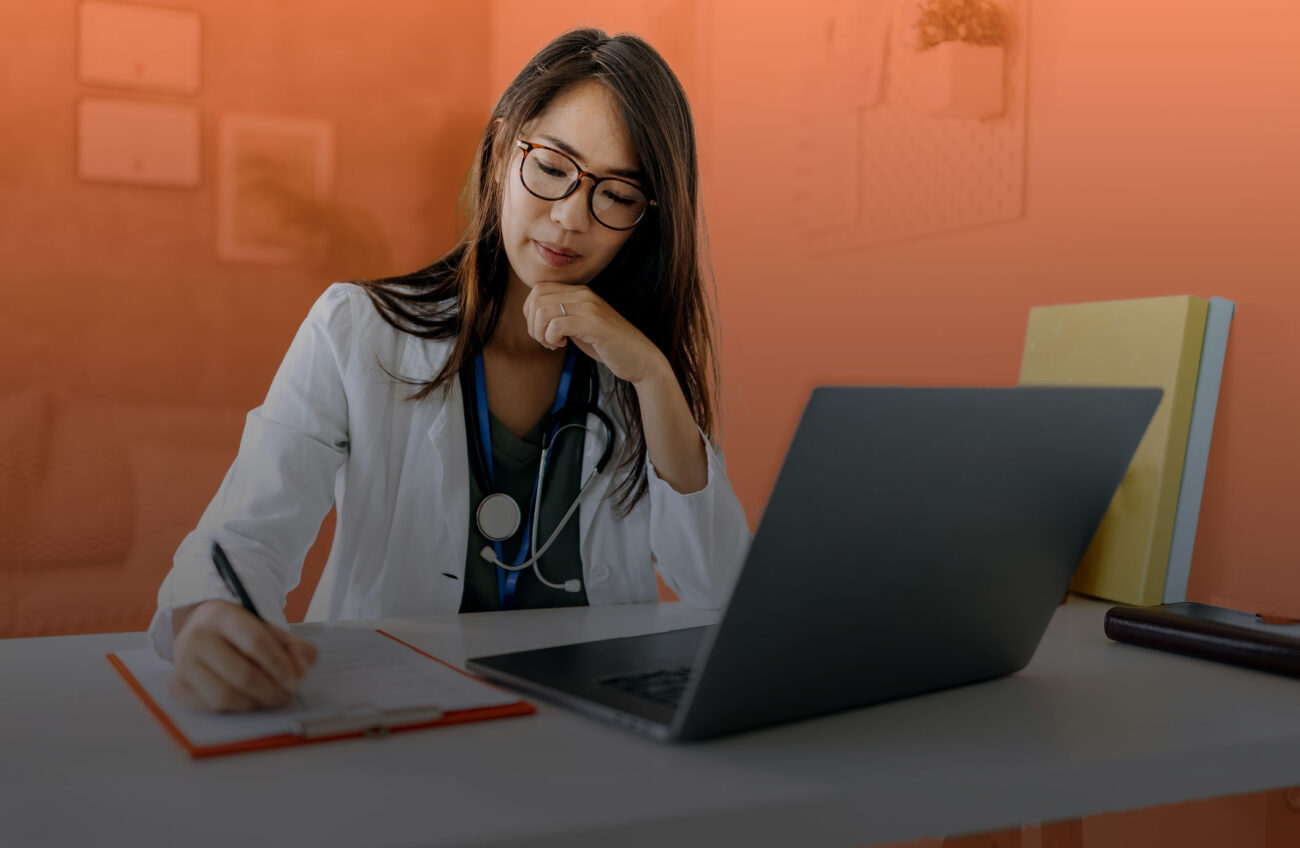 Photo of a female healthcare professional working at her computer