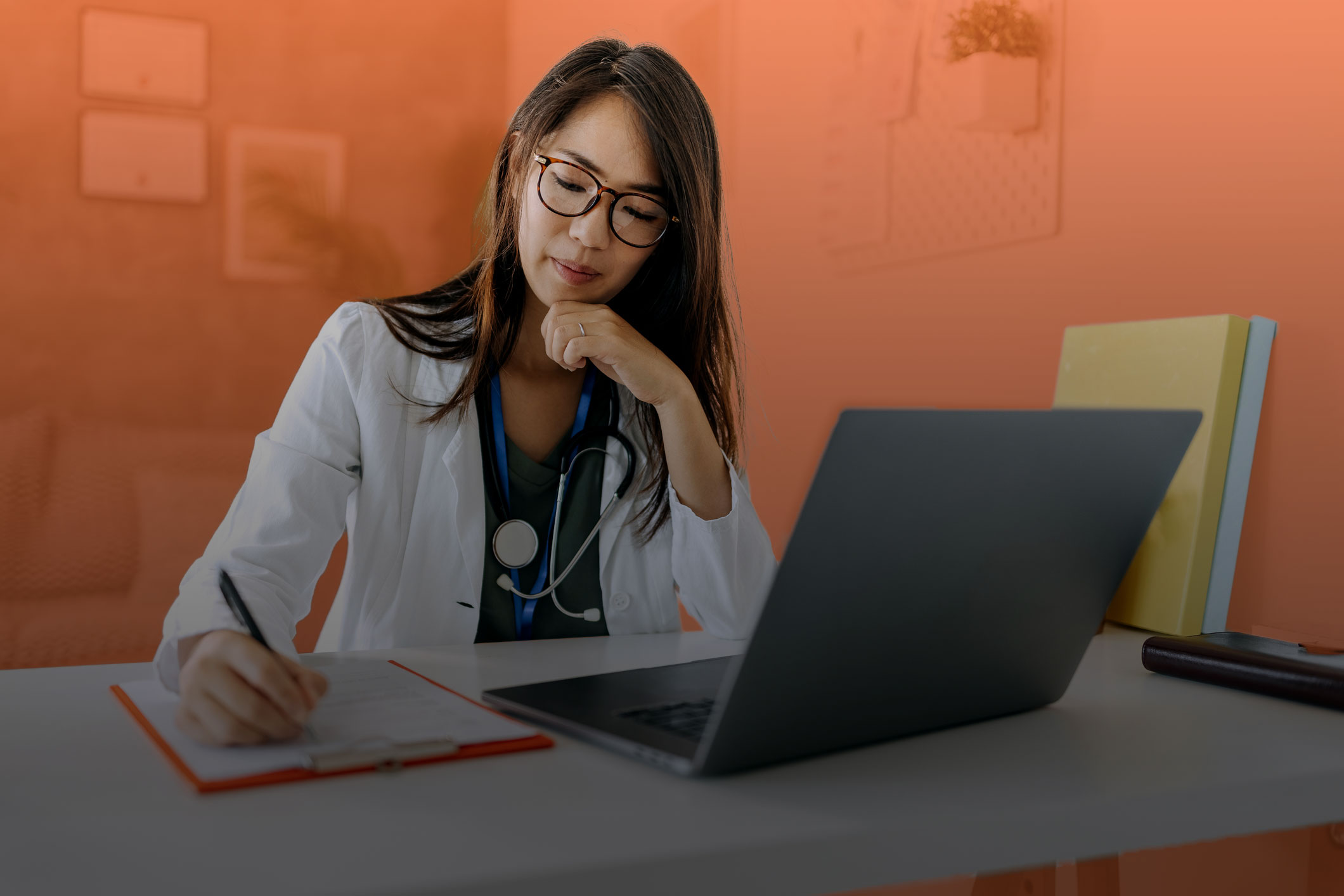 Photo of a female healthcare professional working at her computer