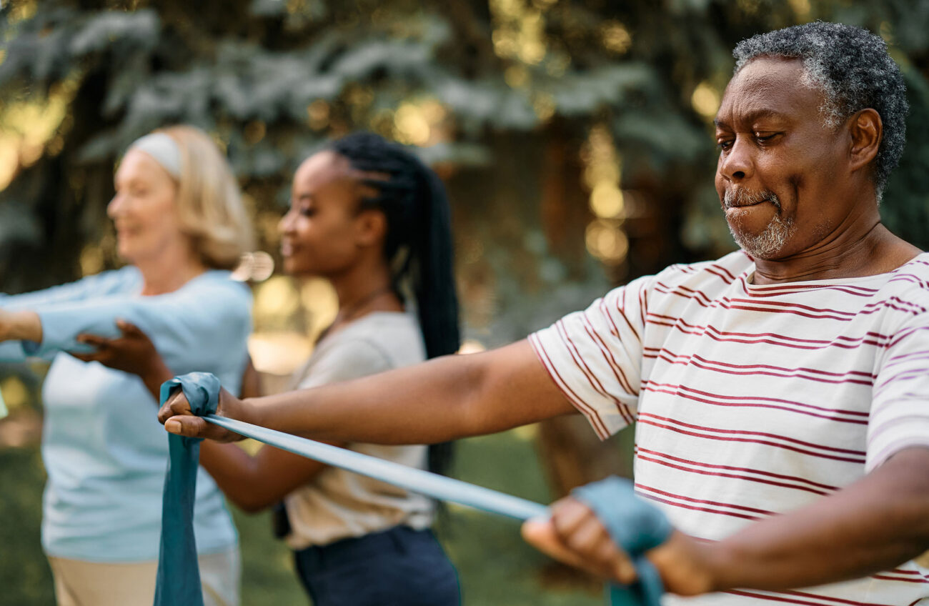Group of older adults exercising with resistance bands