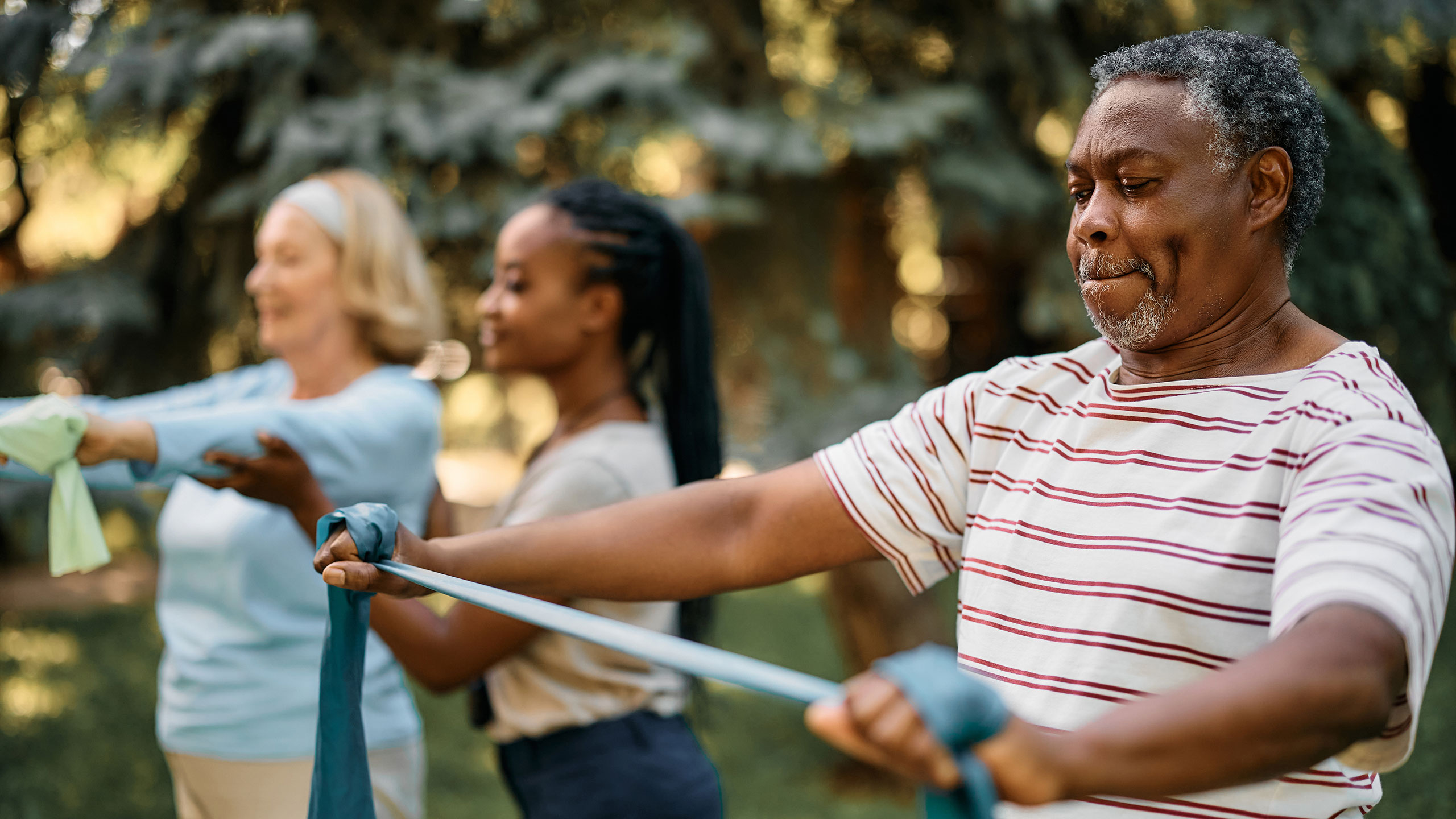 Group of older adults exercising with resistance bands